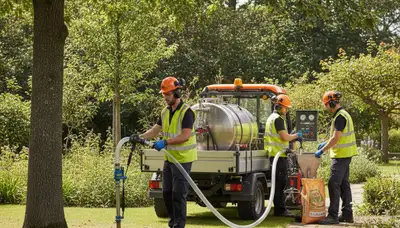 Tree care technician fertilizing trees in Minneapolis, MN for healthier growth and root support